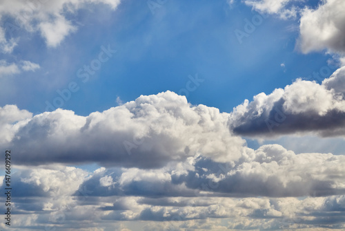 Tablou pe pânză Massive cumulus clouds against a blue sky create a majestic natural landscape, s