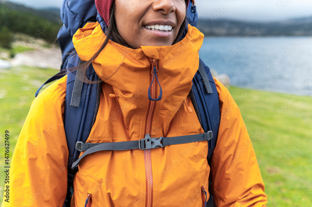 Detail of waterproof technical jacket and backpack on female hiker outdoors Detail of waterproof technical jacket and backpack on female hiker outdoors