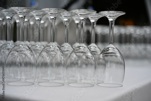 Close-up of upside down wine glasses in a row on a table ready for a party