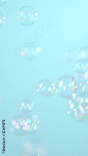 Slow motion of flying soap bubbles on blue background
