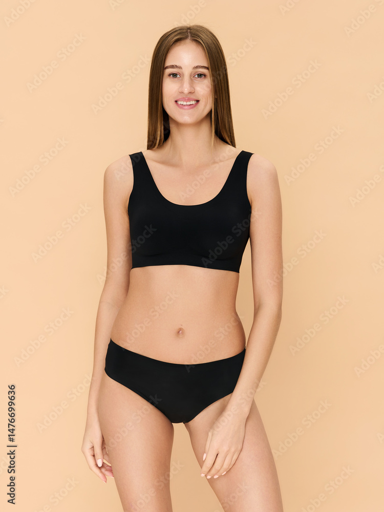 Girl model in underwear posing in studio on beige background. Girl model in underwear posing in studio on beige background.