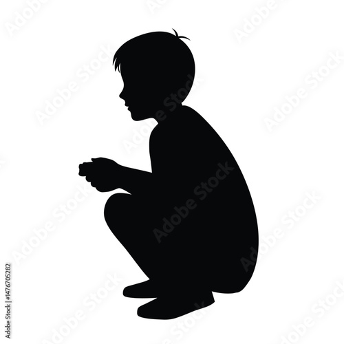 Black silhouette of a young boy squatting isolated on a white background