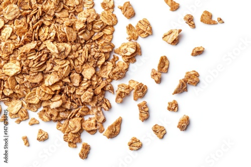 Scattered toasted oat flakes on white background.  Crispy, golden-brown flakes