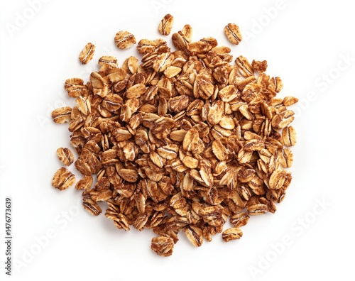 Pile of whole grain oat flakes, scattered atop a plain white background.  Close-up view shows numerous small, irregular-shaped pieces, light tan to golden brown in color