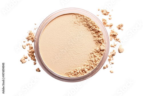 Beige face powder in a round container.  Loose powder scattered around the container