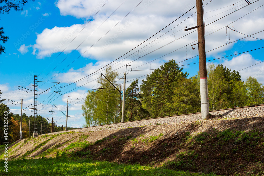 Fototapeta premium Railway embankment with electrified railway tracks