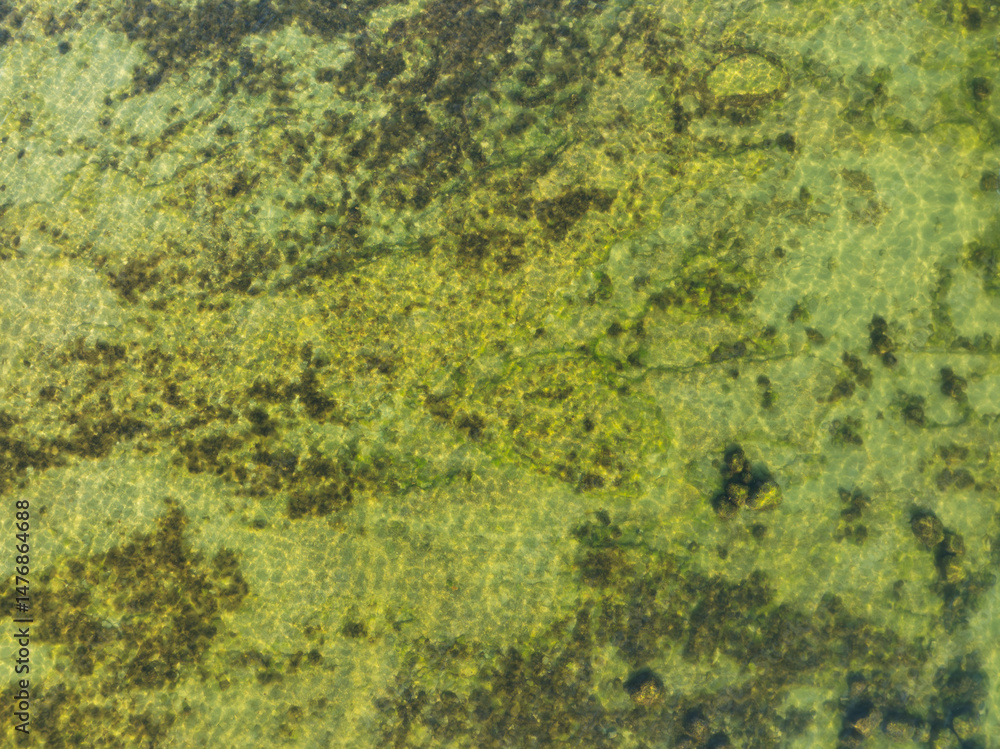 Baltic Sea in shallow waters: abstract background and water texture, top view from a drone, natural beauty. Baltic Sea in shallow waters: abstract background and water texture, top view from a drone, natural beauty.