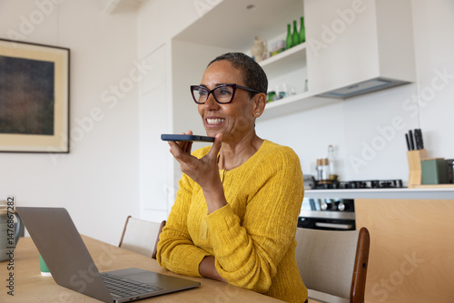 Mature woman using aritificial intelligence at home