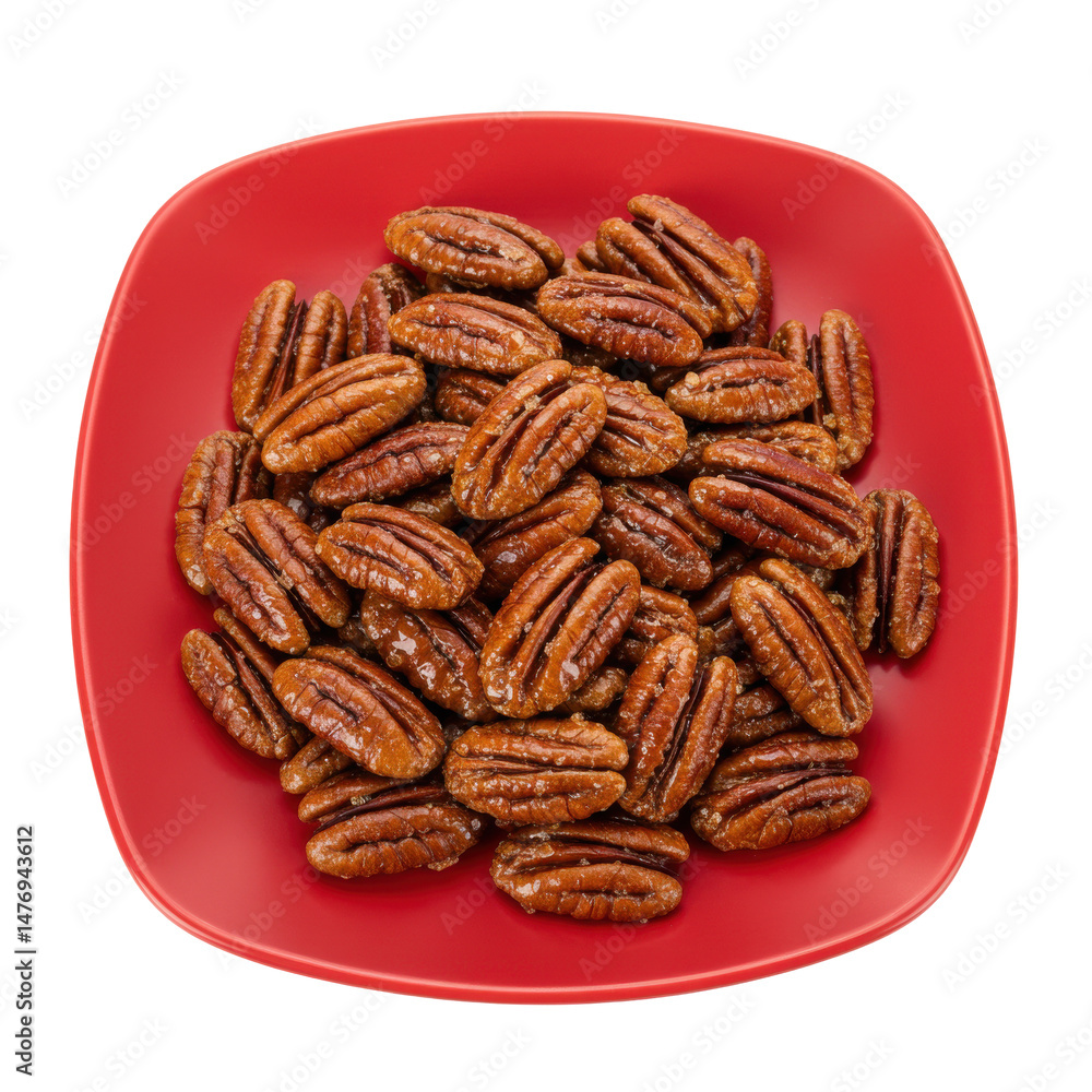 Fototapeta premium A vibrant red plate filled with roasted pecans, showcasing their rich texture and color
