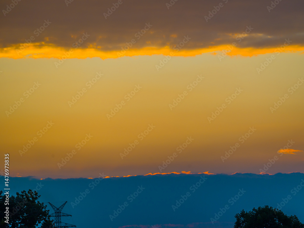 Fototapeta premium Bizarre colorful parallel sky clouds at sunset