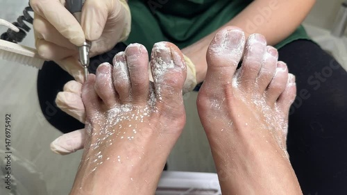 Experienced female master. Professional master gives foot massage and pedicure to client.
