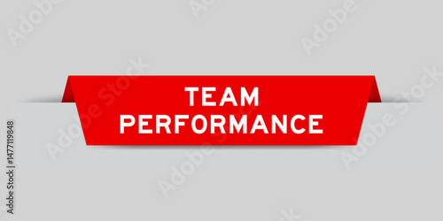 Red color inserted label with word team performance on gray background