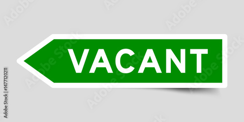 Green color arrow shape sticker label with word vacant on gray background