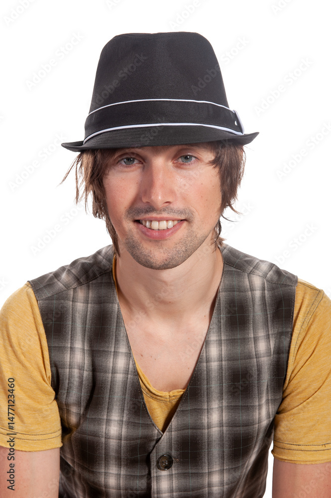 Young man wearing a stylish hat and plaid vest against a bright background Young man wearing a stylish hat and plaid vest against a bright background