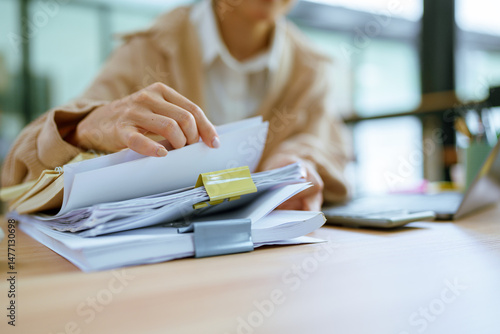 Businessman's hand searching for documents