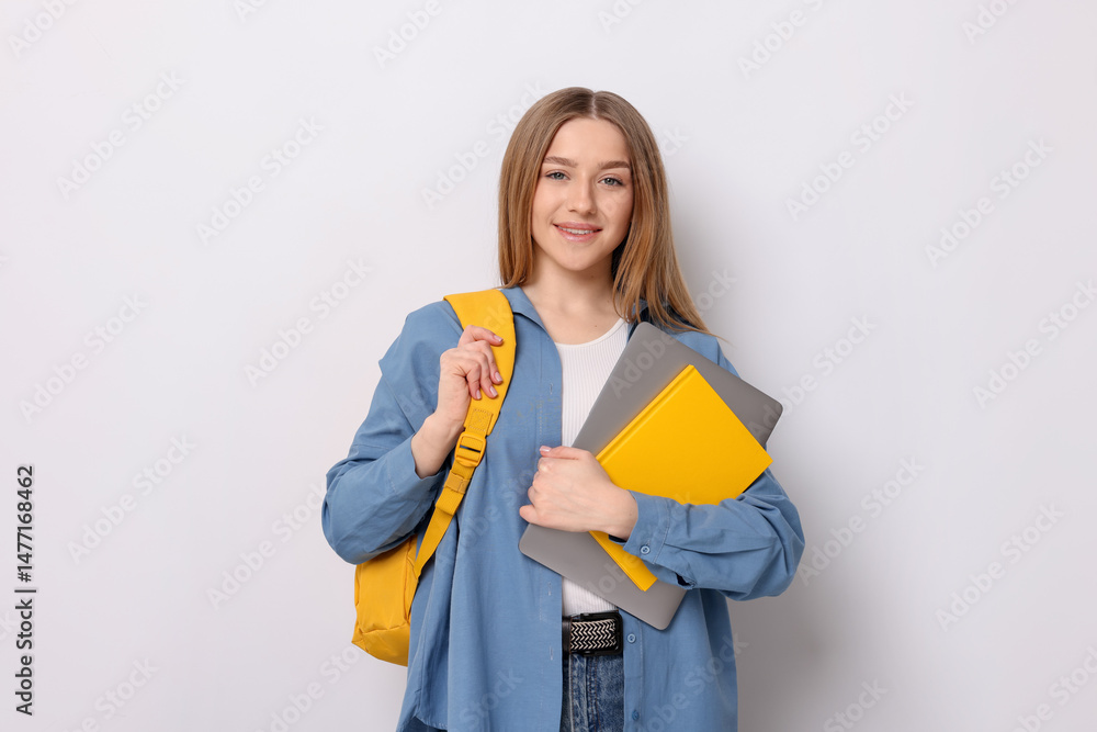 Smiling teenage girl with books and backpack on white background Smiling teenage girl with books and backpack on white background