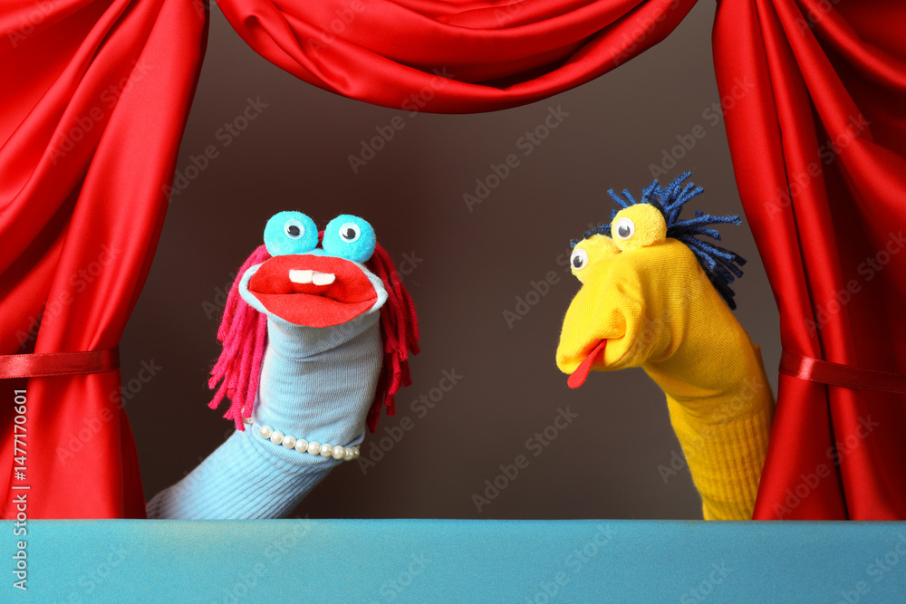 Naklejka premium Creative puppet show on stage with red curtains