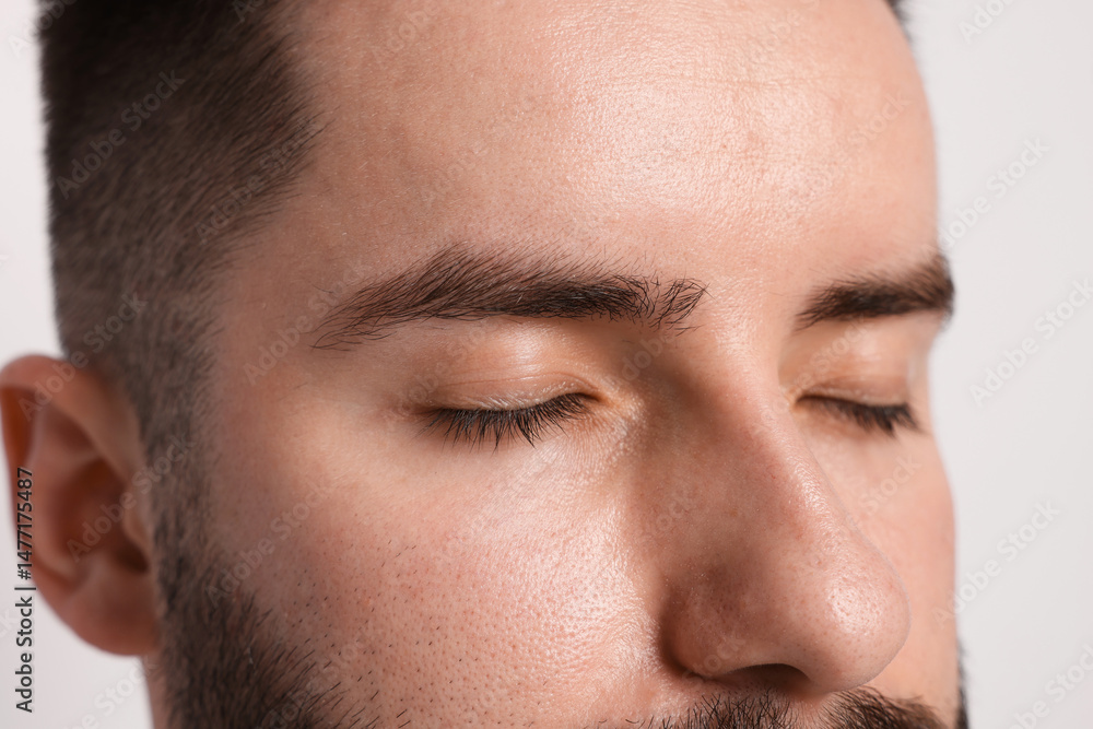 Obraz premium Man before eyebrows correction on light background, closeup