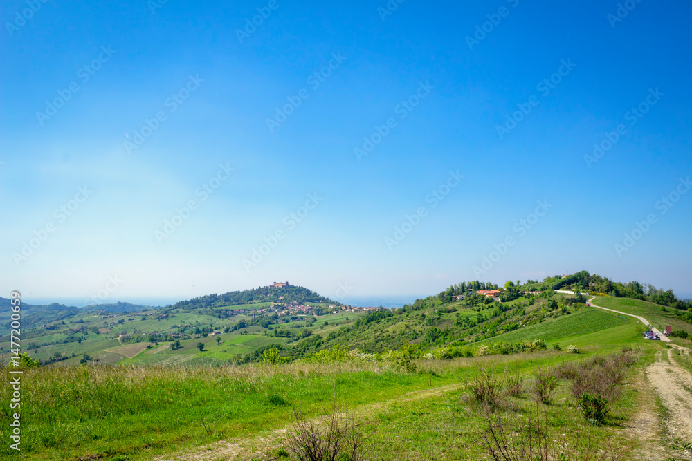 Springtime panorama of the hills range of Oltrepo Pavese. Is a winery area between Lombardy, Emilia and Piedmont Regions (Northern Italy), mainly in the Pavia Province. Springtime panorama of the hills range of Oltrepo Pavese. Is a winery area between Lombardy, Emilia and Piedmont Regions (Northern Italy), mainly in the Pavia Province.