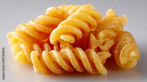 A pile of yellow pasta with a grainy texture photo