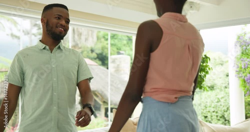 African American couple dancing joyfully at home, enjoying each other's company
