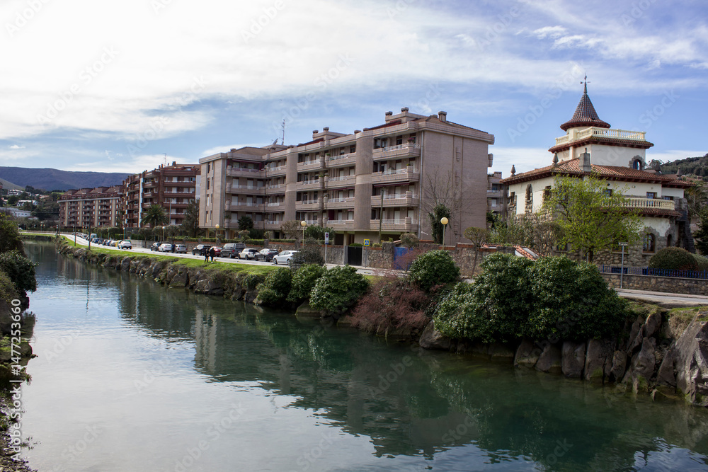 Fototapeta premium river canal along the road and houses; city landscape