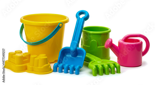 Colorful plastic beach toys including bucket shovel rake watering can and castle molds isolated on white