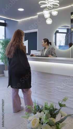 Patient leaving reception desk at modern dental clinic