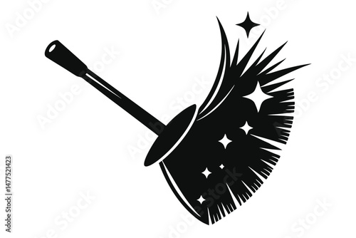 A black cleaning broom makes stars while sweeping a surface in the home