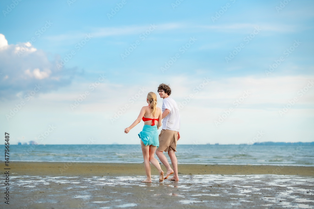 Man and woman walking along beach, hand in hand, with the horizon stretching endlessly before them, symbolizing hope and unity... Man and woman walking along beach, hand in hand, with the horizon stretching endlessly before them, symbolizing hope and unity...