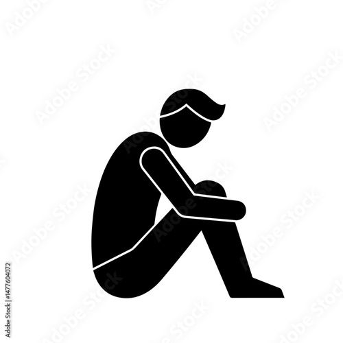 Silhouette of a seated person with knees drawn to chest in despair  
