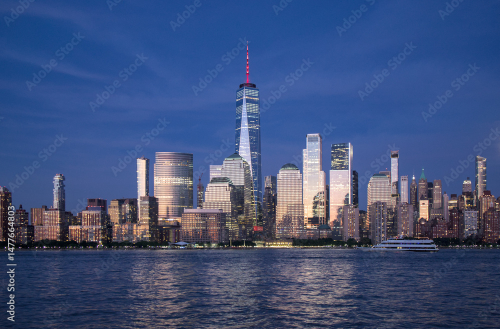 Fototapeta premium new york city skyline view during blue hour just after sunset (dusk nightfall night time photography from jersey city waterfront) hudson river downtown skyscrapers tall commercial buildings reflecting