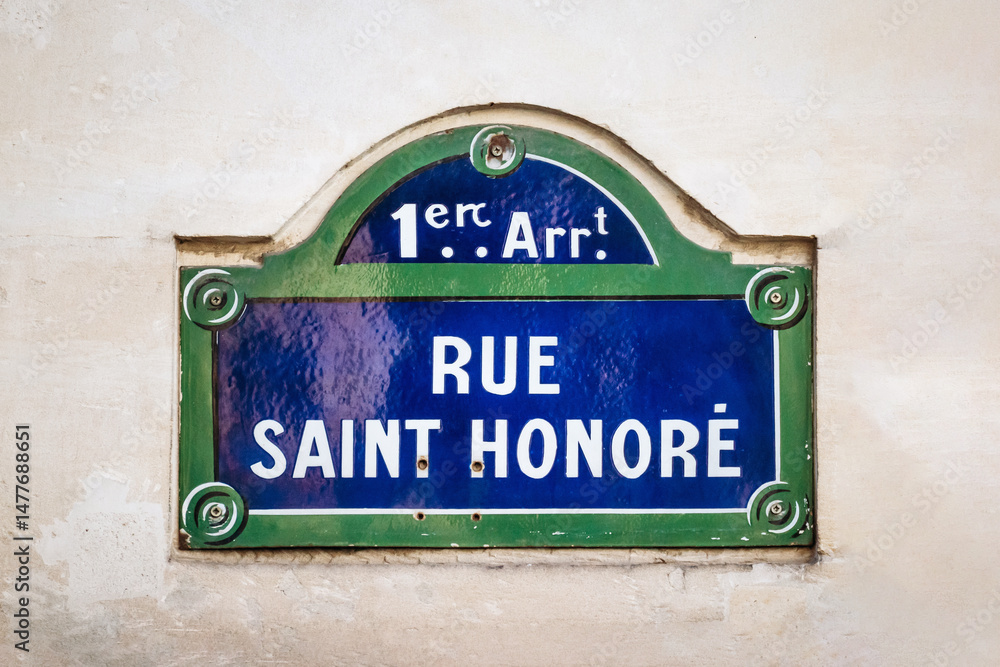 Obraz premium Rue Saint Honore street sign, 1st arrondissement, blue and green plaque on beige wall
