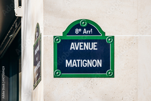 Avenue Matignon street sign on beige wall, 8th arrondissement of Paris