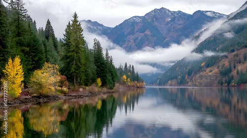 Fototapeta Naklejka Na Ścianę i Meble -  mountain lake at dawn with low-hanging clouds and still waters