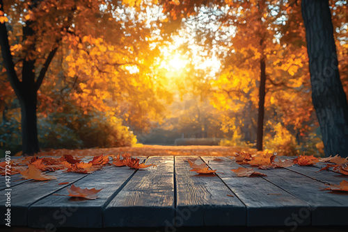 Autumn leaves scatter on an old wooden table against the backdrop of a golden forest