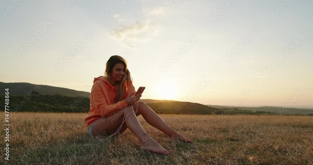 custom made wallpaper toronto digitalYoung woman using smartphone at sunset in a field