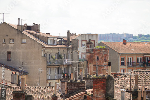 Urban rooftops showcase the architectural charm of Toulouse, France under a clear sky