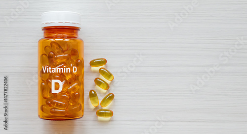 Amber Vitamin D Supplement Bottle with Capsules on Light Wood