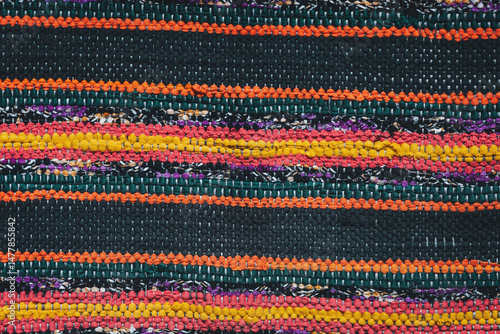 Vibrant textile weaving showcasing intricate patterns and colors from a local artisan market during a sunny afternoon