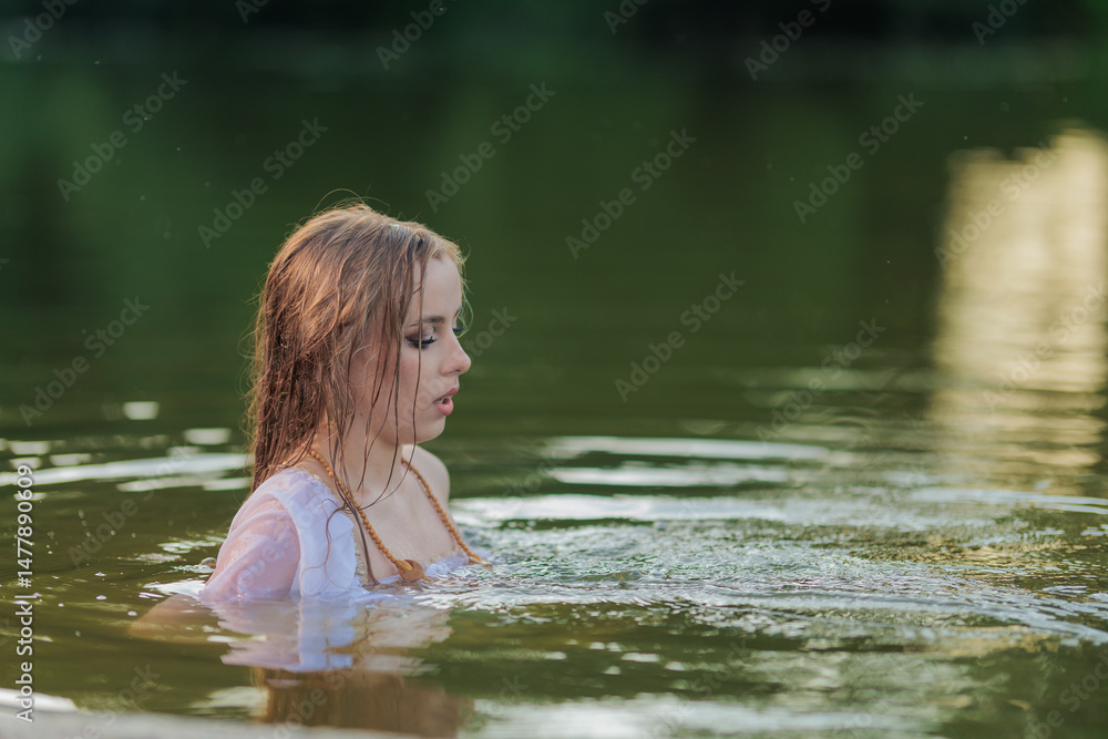 Fototapeta premium Beautiful Girl with long hair swims and dances in water