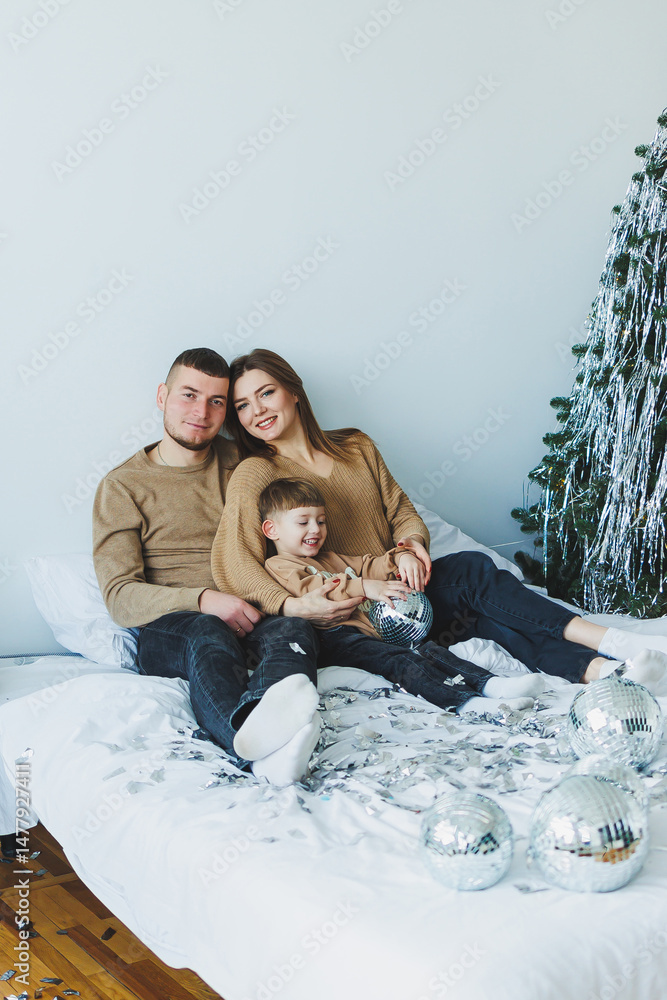 A Joyful Family is Celebrating Togetherness and Bonding During the Wonderful and Festive Christmas Season with Beautiful Christmas Decorations Surrounding Them to Enhance the Cheerful Atmosphere