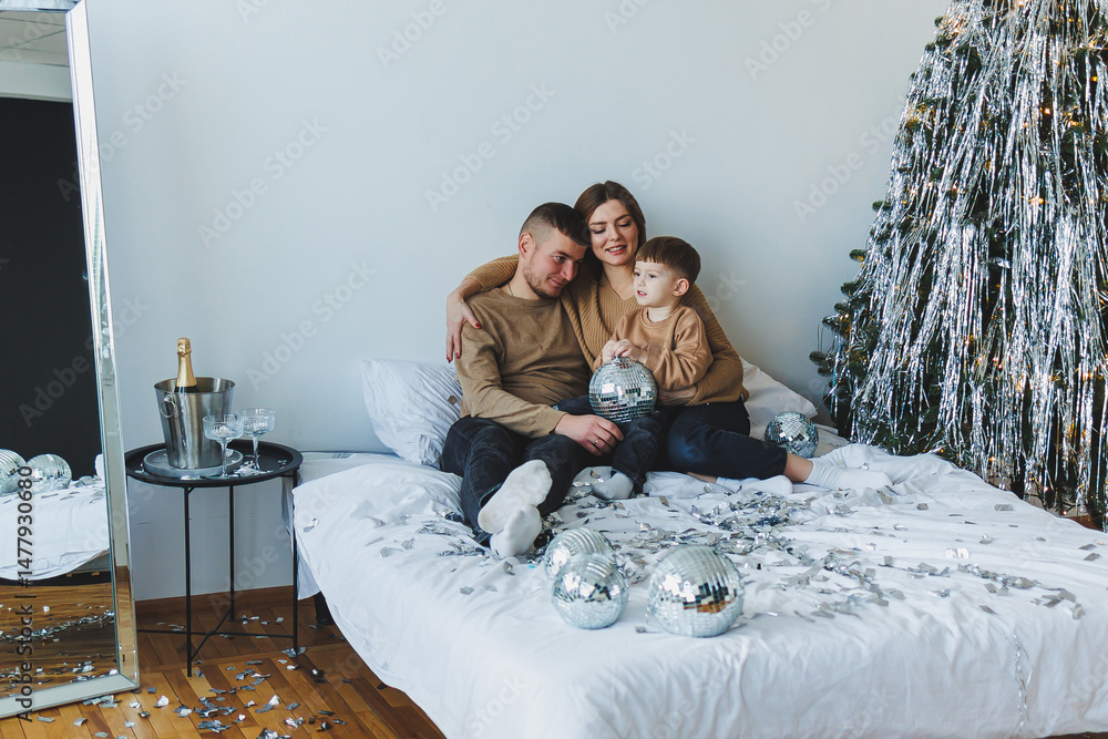This image captures a beautiful and cozy family holiday portrait decorated with sparkling decor and filled with cheerful vibes, perfect for celebrating the joyful moments of the season