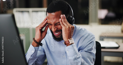 Photography Black man, call center and computer with stress at night, headache or pain with communication or telecom mistake