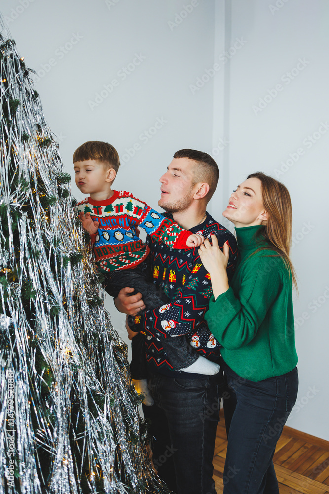 A joyful family celebrates the holiday season in their cozy home, enjoying laughter and love around a beautifully decorated Christmas tree filled with colorful decorations and thoughtful gifts