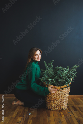 Obraz na płótnie A Woman Embracing a Large Basket Filled with Lush Green Plants in a Beautiful, Minimalist Indoor Setting That Exudes a Sense of Calm and Natural Beauty, Perfect for Wellness and Relaxation w salonie