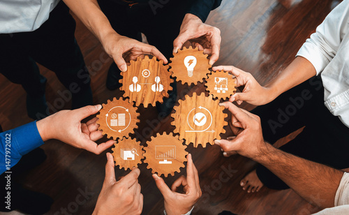 A dynamic scene of hands holding wooden gears, symbolizing collaborative efforts in business. This image captures teamwork and innovation ideal for corporate use. Amity