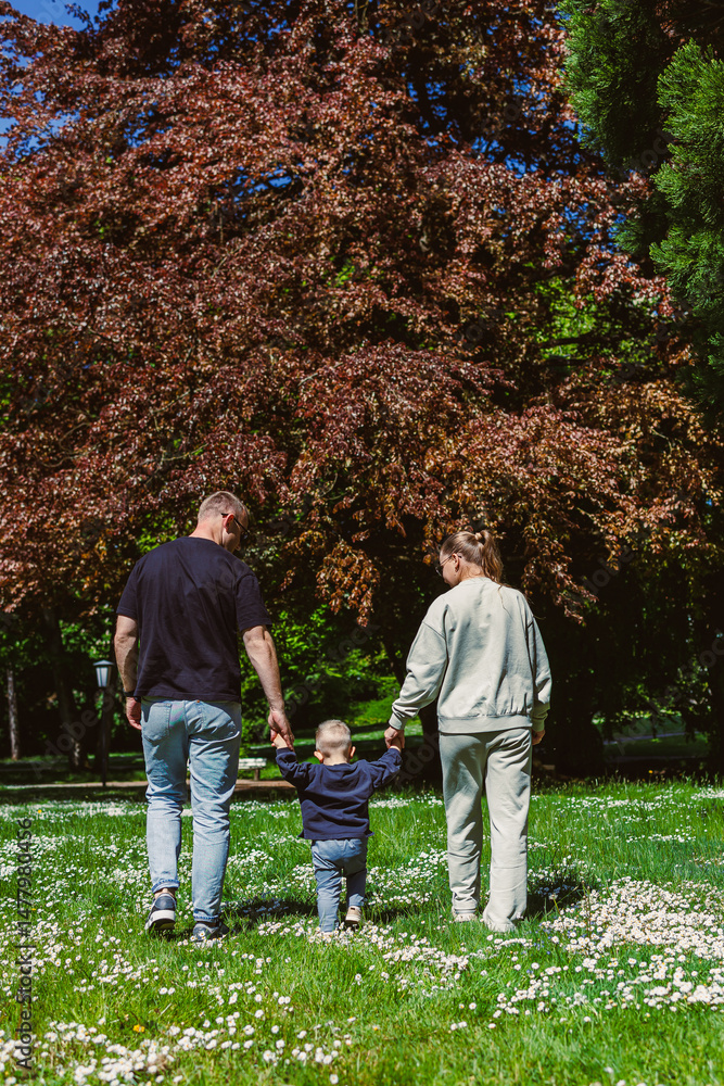 Family Bonding Moments A Heartwarming Day Spent in Nature with a Child in Hand, Celebrating Love, Joy, and Togetherness Amidst Beautiful Scenery and Blossoming Flowers in the Sunshine