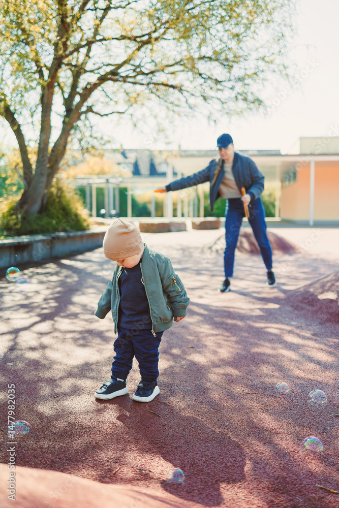 Playful Moments A child joyfully exploring the wonders of nature in the company of a caring caregiver within a bright and cheerful outdoor playground filled with laughter and sunshine
