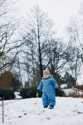 A Charming Child in Winter Wonderland A Young Adventurer Embraces the Snowy Outdoors with Pure Joy and Unending Curiosity as they explore the magical landscape with excitement and wonder